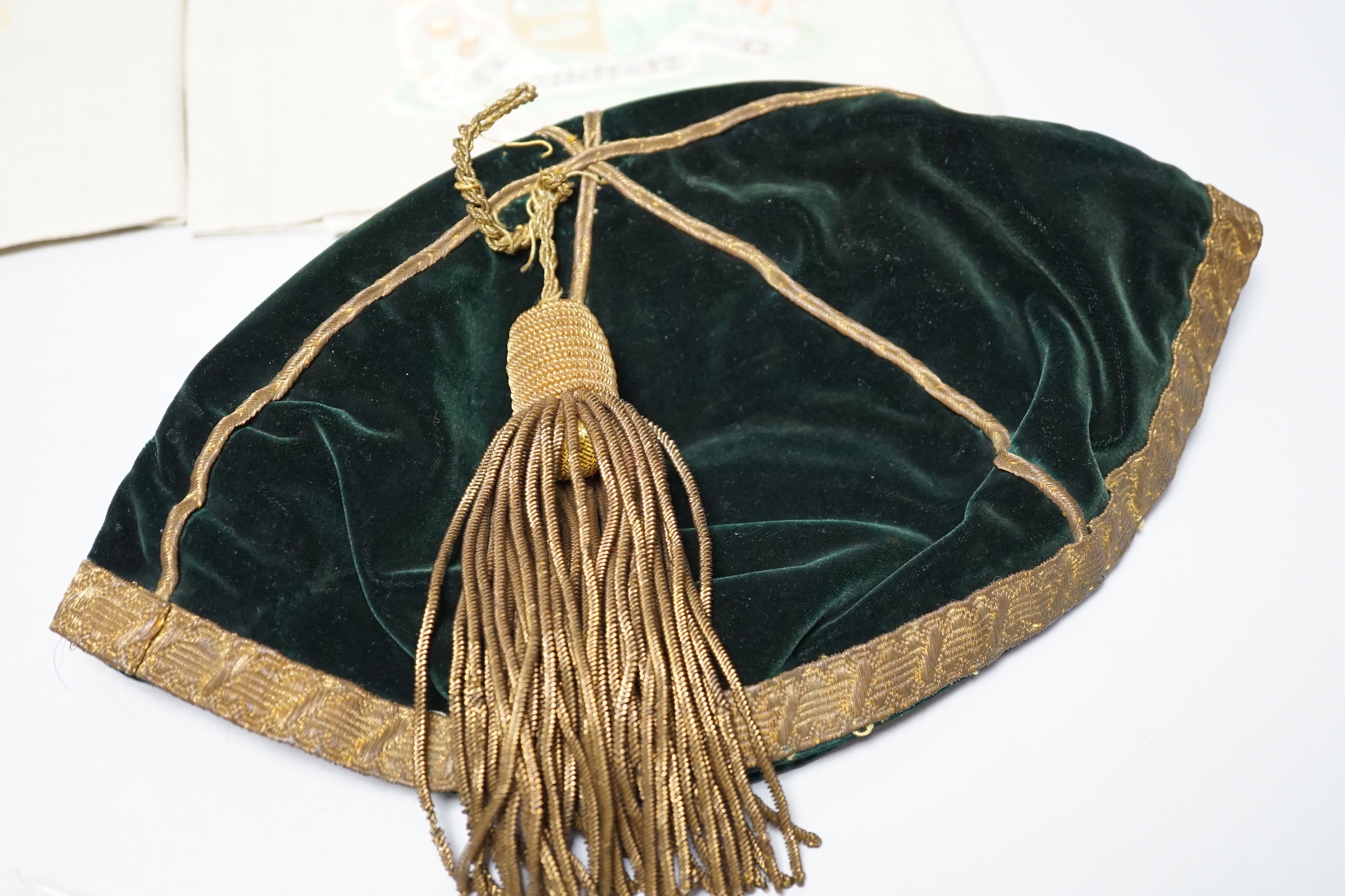 Two South African late 19th century damask railway napkins and a velvet rugby or cricketing cap